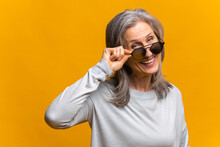 Photo Of Confident Mature Female Model Wears Trendy Sunglasses, Prepares For Date, Isolated On Yellow Background, Has Fashion Look