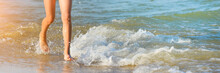 Running Girl Legs On The Sea Beach. Long Summer Banner With Copy Space. Close Up Of A Young Girl's Legs Walking Or Running On The Beach With Waves And Seafoam.