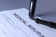 © Tony Moore - Medical Insurance Form with pen lain across the page