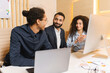 © Vadim Pastuh - Young confident woman talking with employees in the office. Multiracial man in glasses explains something to his team of coworkers