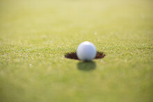 Close-up Of Golf Ball At Golf Hole