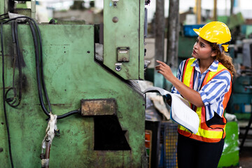 Wall Mural - African American engineer Woman wearing safety goggles control lathe machine to drill components. Metal lathe industrial manufacturing factory. Engineer Operating  lathe Machinery