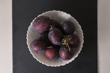 Plums In A White Plate