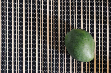 Wall Mural - green mango on a reed lining - top view