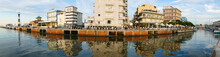 Extra Wide Panorama Of The Canal That Divides Cattolica From Gabicce With The Buildings That Are Reflected In The Water At Sunset