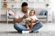 © Prostock-studio - Caring Black Dad Feeding His Adorable Infant Baby From Spoon At Home