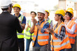 © NVB Stocker - Unity and teamwork concept. Container worker audience applauding in morning brief meeting before going to work. Congratulation Celebrate success concept.