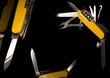 Swiss Pocket Knife. Yellow Penknife Isolated on the Black Background. Gift for Men. Luxurious Thing. 