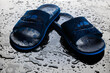 Pair of Wet Flipflops on a Wet Floor with Water Drops. Swimming Equipment.
