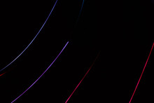 Abstract Background Of Red And Purple Lines On Black.