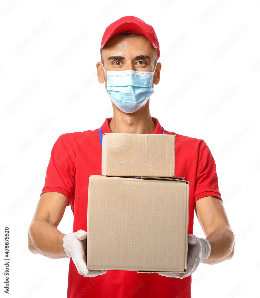 Male courier in medical mask and with parcels on white background