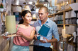 © JackF - Man and woman is choosing new table lamp for her home in the store