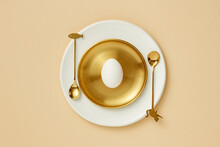 Flatlay Of Easter Egg On Golden Plate