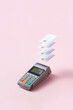 © Yaroslav Danylchenko/Stocksy - Terminal with credit cards on pink background