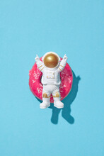 Happy Astronaut Lying On Donut