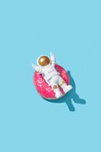 Cheerful Astronaut Relaxing On Donut