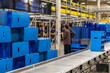 © Raymond Forbes LLC/Stocksy - Manager meets with worker at modern Warehouse