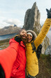 © Kike Arnaiz/Stocksy - Cheerful travelers taking selfie in mountains