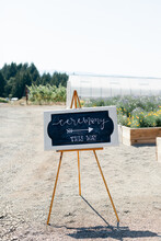 Chalkboard Sign Pointing Towards Wedding Ceremony