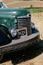 Beer Sign Sitting On Old Truck