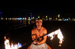 © Igor Kardasov/Stocksy - fire show performer twists a fire rod