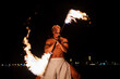 © Igor Kardasov/Stocksy - Strong latin performer twirling fire rod