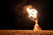 © Igor Kardasov/Stocksy - showman breathes fire from his mouth