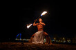 © Igor Kardasov/Stocksy - man twirling baton with dynamic flame