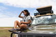 © Kike Arnaiz/Stocksy - Woman tourist in African safari