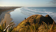 © Amos Chapple/Stocksy - A male hiker looks down the long beach ahead.