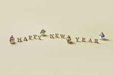 Happy New Year Message With Penguins Statuettes
