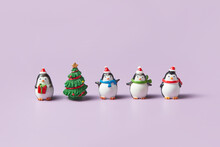 Ceramic Statuettes Of Penguins And Christmas Tree