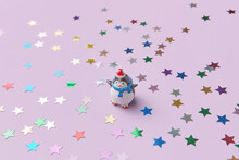 Penguin Figurine With Confetti On Pink Background