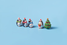Ceramic Penguins And Christmas Tree In Studio