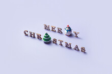 Merry Christmas Phrase With Ceramic Tree And Penguin