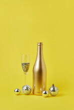 Festive Composition Of Bottle, Glass And Baubles