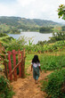 © Kike Arnaiz/Stocksy - Unrecognizable woman walking towards lake
