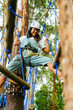 © Kike Arnaiz/Stocksy - Arab woman walking on rope course