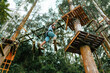 © Kike Arnaiz/Stocksy - Active woman walking on rope course