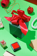 A Green Gift Box With A Red Lace
