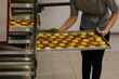 © Liliya Rodnikova/Stocksy - Anonymous baker put backing pan with macaroons on tray