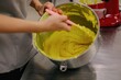 © Liliya Rodnikova/Stocksy - Anonymous woman mixing yellow dough