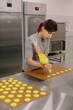 © Liliya Rodnikova/Stocksy - Baker with pastry bag in kitchen