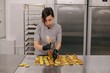 © Liliya Rodnikova/Stocksy - Woman chef making macaroons in kitchen