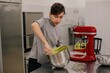 © Liliya Rodnikova/Stocksy - Baker stirring dough in bowl