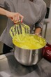 © Liliya Rodnikova/Stocksy - Baker stirring dough in bowl