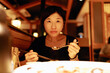 © Pansfun Images/Stocksy - Young female having dinner
