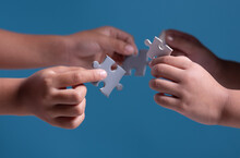 Teamwork And Solution Concept,Kids Hands Holding Jigsaw