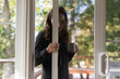 © Lauren Lee/Stocksy - Woman closing screen door