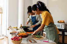 Women With Apron Cooking Together
